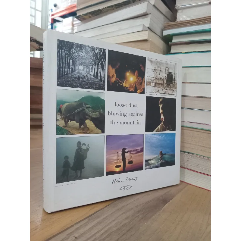 Loose dust blowing against the mountain - Helen Savory 715098