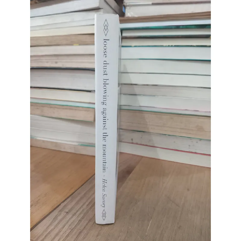 Loose dust blowing against the mountain - Helen Savory 715098