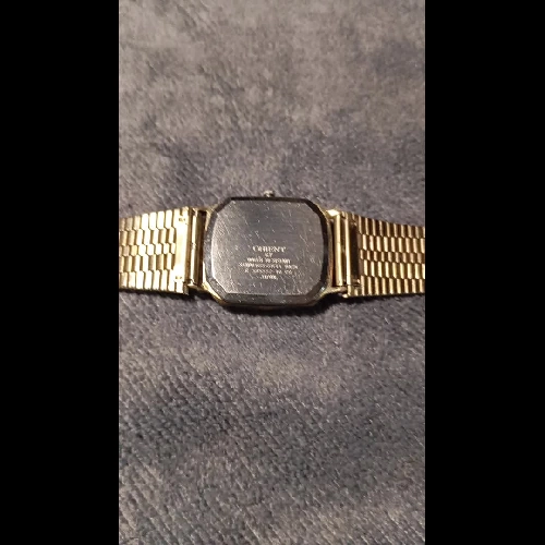 Đồng hồ si nhật bản Orient dáng tank bọc vàng cả dây khoaast