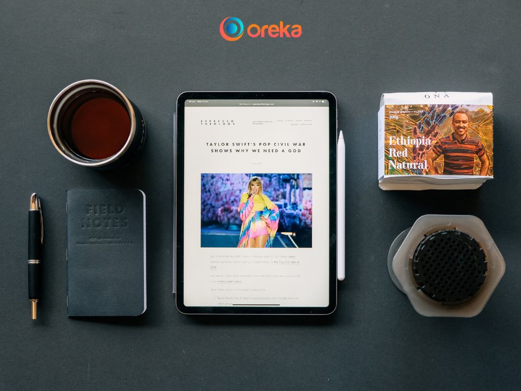 lỗi màn hình ipad, hình ảnh chiếc ipad được đặt trên bàn, bên cạnh có 1 cuốn sách, 1 cuốn sổ, 1 cốc nước, 1 cây bút